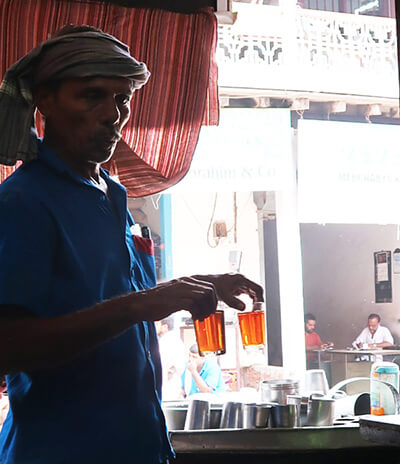 Man in turban holding drinks
